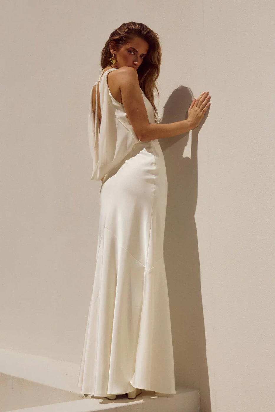 Side leaning pose, Runaway The Label Gabriella Ivory cowl maxi dress with open back